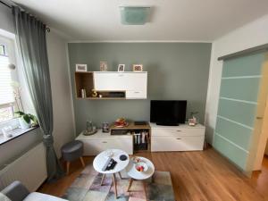 a living room with a couch and a tv at Ferienwohnung Monteurwohnung Gevelsberg in Gevelsberg