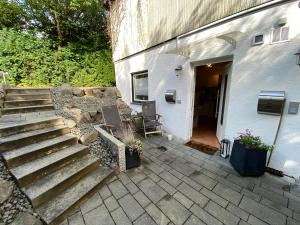 a patio with stairs and a white building at Ferienwohnung Monteurwohnung Gevelsberg in Gevelsberg