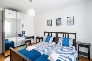 a bedroom with two beds and a mirror at Downtown Apartment Helena in Opatija