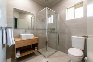 a bathroom with a toilet, sink, and shower at Nightcap at Waterfront Hotel in Maroochydore