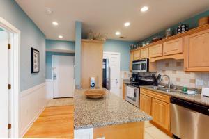 a kitchen with wooden cabinets and a counter top at Shipwatch 2173 in Kiawah Island