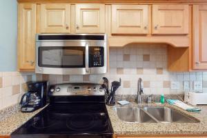a kitchen counter with a microwave and a sink at Shipwatch 2173 in Kiawah Island