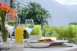 a table with a plate of food and glasses of orange juice at Hotel Tamanaco Caracas in Caracas