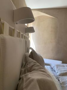 a bedroom with a bed with pillows and a lamp at Rennweg 114 in Merano