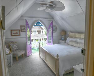 a bedroom with a bed with a purple door at Narragansett House in Oak Bluffs