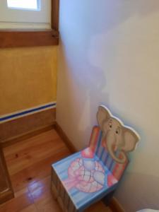 a toy elephant sitting in a chair in a room at Casa Mateus - Colares, Parque Natural Sintra Cascais in Sintra