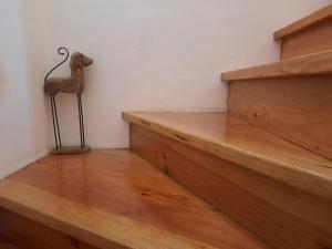 a room with wooden stairs and a statue of a camel on the wall at Casa Mateus - Colares, Parque Natural Sintra Cascais in Sintra