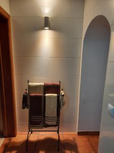 a towel rack in a bathroom with a light at Casa Mateus - Colares, Parque Natural Sintra Cascais in Sintra