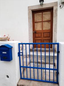 a blue gate in front of a door at Casa Mateus - Colares, Parque Natural Sintra Cascais in Sintra