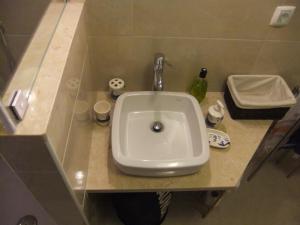 a white sink in a bathroom with a counter at Casa Mateus - Colares, Parque Natural Sintra Cascais in Sintra