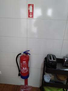 a fire hydrant is hanging on a wall at Casa Mateus - Colares, Parque Natural Sintra Cascais in Sintra