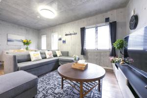 a living room with a couch and a table at Uhome Otsuka Villa in Tokyo