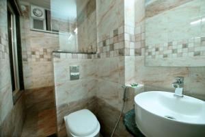 a bathroom with a sink and a toilet at Hotel Sunflower Udaipur in Udaipur