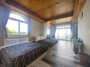 a bedroom with two beds and a large window at Star Villa in Ren'ai
