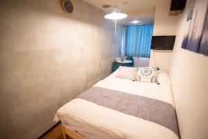 Giường trong phòng chung tại Vail sta Takenotsuka