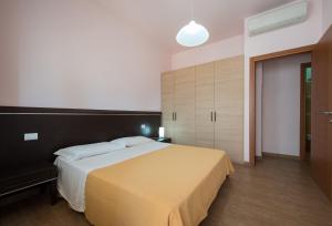 Postel nebo postele na pokoji v ubytování Residence Palazzo Gasparroni