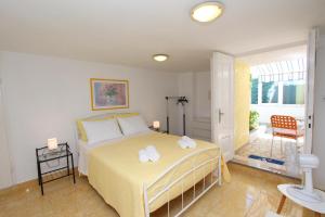 a bedroom with a bed with two towels on it at Apartments Knezović in Rovinj