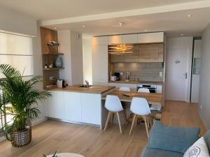 a kitchen and living room with a table and chairs at La Baule Family in La Baule +4 photos