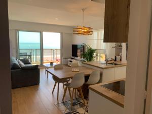 a kitchen and living room with a view of the ocean at La Baule Family in La Baule