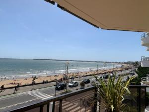 a view of the beach from the balcony of a condo at La Baule Family in La Baule