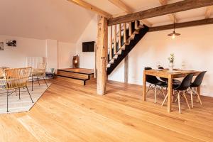 - un salon avec une table et des chaises ainsi qu'un escalier dans l'établissement Landhaus Fiete, à Ihlow