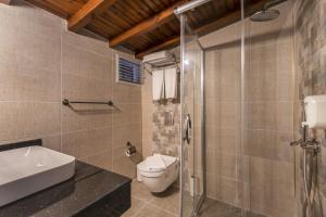 a bathroom with a toilet and a sink and a shower at La Paloma Hotel in Antalya