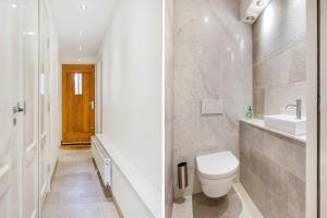 a white bathroom with a toilet and a sink at Artis Plantage Apartment in Amsterdam