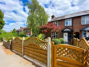 a wooden fence in front of a house at New Contractor House Near LLA Airport & M1 in Luton