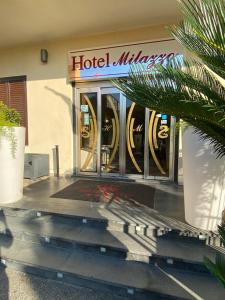 a hotel with a sign on the front of a building at Hotel Milazzo in Milazzo