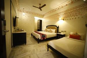 Laxmi Palace Heritage Boutique Hotel客房内的一张或多张床位