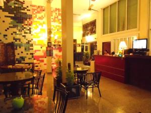 a restaurant with tables and chairs and a bar at Lodge 61 Hotel in Bangkok