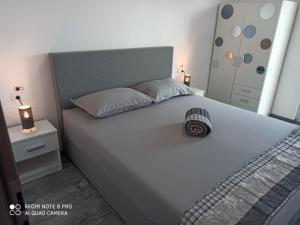 a bedroom with a large bed with a gray headboard at Villa Luna in Biograd na Moru