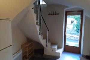 a staircase in a house with a window and a door at Maison de bourg in Vic-le-Comte +2 photos