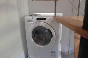 a white washing machine in a room with a counter at Maison de bourg in Vic-le-Comte