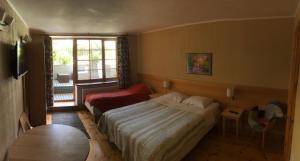 a hotel room with a bed and a window at Vila Mares in Palanga