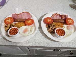 two plates of food with meat and vegetables on a counter at 74Belgravia in Torquay