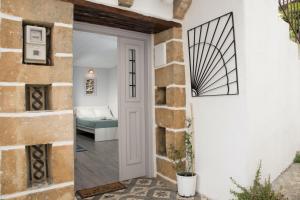 a door leading to a bedroom in a house at Studio Cozy - In the Heart of Skyros Village in Skiros