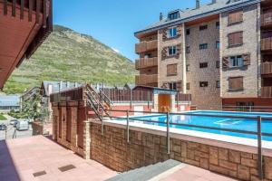 a swimming pool on the side of a building at Vielha Centro Estudio in Vielha