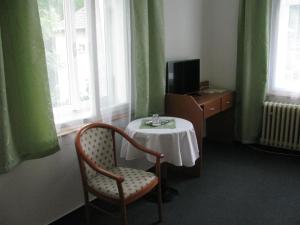 Televízia a/alebo spoločenská miestnosť v ubytovaní Villa Dagmar