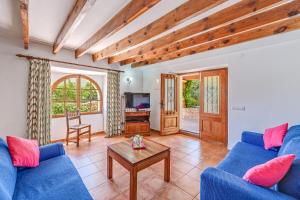 a living room with two blue couches and a table at Ca n Tres Cames Cuxach de n Joan in Pollença