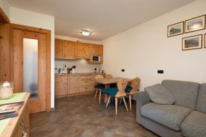 a kitchen and living room with a table and a couch at Chalet Mistral in Livigno