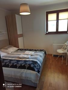 Posteľ alebo postele v izbe v ubytovaní Apartament Krokus SPA