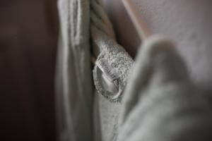 a close up of a white robe with a button at Studio Cozy - In the Heart of Skyros Village in Skiros