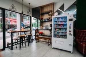 a restaurant with a refrigerator and a table at B Lot Hotel in Kuala Lumpur