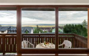 a table and chairs on a balcony with a view at Pionier in Starý Smokovec