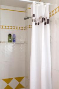 a white shower curtain in a bathroom with a shower at Ático con terraza en Graus-Pirineo de Huesca in Graus +24 photos