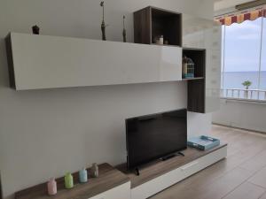 a living room with a flat screen tv on a wall at BlancMar Apartament in Calpe