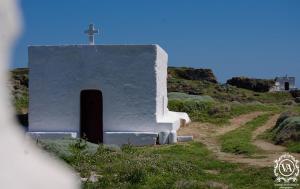 a small chapel with a cross on a hill at Studio Cozy - In the Heart of Skyros Village in Skiros