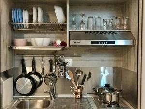 a kitchen with a sink and utensils at Studio Cozy - In the Heart of Skyros Village in Skiros