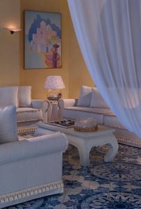 a living room with couches and a coffee table at Miramare E Castello in Ischia